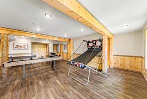 This spacious game room is packed with fun, featuring a basketball arcade, shuffleboard, and board games for all ages! Perfect for friendly competition and group entertainment, this lively space is designed for unforgettable game nights.