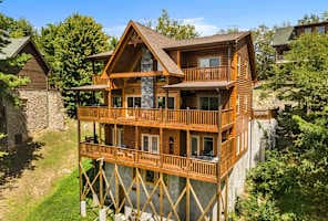Luxury log cabin rental near downtown Pigeon Forge, offering multi-level decks, stunning mountain views, and proximity to top attractions—perfect for family vacations or group getaways in the Smoky Mountains.