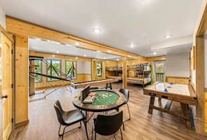 Enjoy endless entertainment in this spacious game room, featuring a poker table, air hockey, and more! Perfect for friendly competition and group fun, this lively space offers something for all ages. A great spot to relax and make lasting memories!