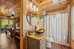 This full bathroom offers modern comfort with fresh towels, toilet paper, hand soap, body soap, and a hair dryer. Featuring a walk-in shower, granite vanity, and cozy cabin charm, it's stocked with essentials to ensure a refreshing & hassle-free stay
