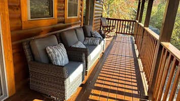 Lounge on the comfortable outdoor sofa and take in the fresh mountain air from the covered deck. This cozy space is perfect for morning coffee, evening chats, or simply unwinding in nature. Enjoy the peaceful surroundings in true cabin comfort!