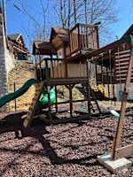 Exciting outdoor play area for kids! Featuring a wooden playhouse, swings, climbing wall, and thrilling slides. A perfect space for little ones to have fun while parents relax. Safe, family-friendly, and designed for adventure!