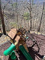 Exciting outdoor play area for kids! Featuring a wooden playhouse, swings, climbing wall, and thrilling slides. A perfect space for little ones to have fun while parents relax. Safe, family-friendly, and designed for adventure!