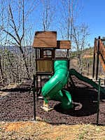 Exciting outdoor play area for kids! Featuring a wooden playhouse, swings, climbing wall, and thrilling slides. A perfect space for little ones to have fun while parents relax. Safe, family-friendly, and designed for adventure!