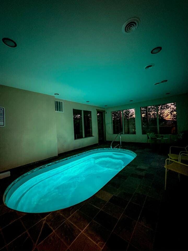 Enjoy a private, year-round heated indoor pool with 24/7 access! Perfect for families, couples, and groups, this space features a secure key door for child safety and scenic views. Relax in a climate-controlled oasis, ideal for any season.