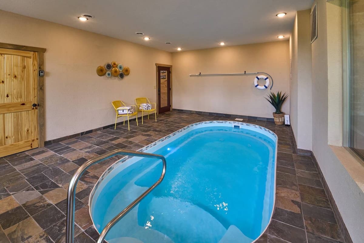 Enjoy a private, year-round heated indoor pool with 24/7 access! Perfect for families, couples, and groups, this space features a secure key door for child safety and scenic views. Relax in a climate-controlled oasis, ideal for any season.