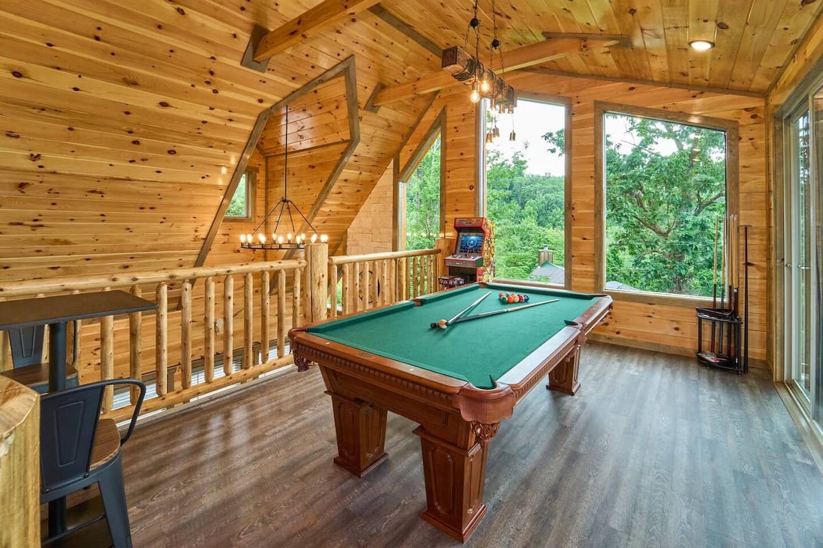 Unwind in the game room, where adults can enjoy a pool table while kids have fun on two arcade machines! This cozy cabin-style space is perfect for friendly competition, late-night games, and family entertainment.