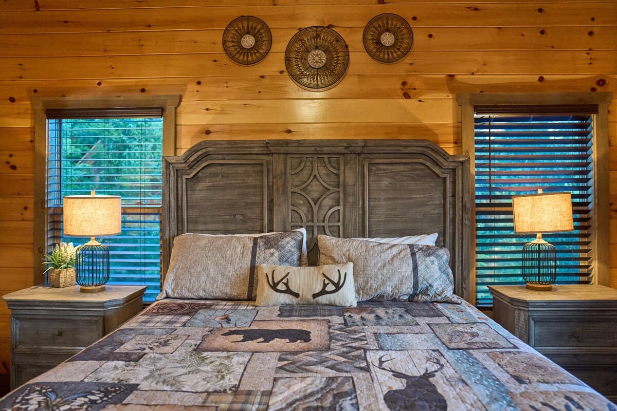 Unwind in this cozy king-size bedroom with a dresser, TV, closet, and private full bathroom. Step onto the deck with seating to enjoy peaceful nature views. Designed for comfort and relaxation, this rustic retreat is perfect for a restful stay!