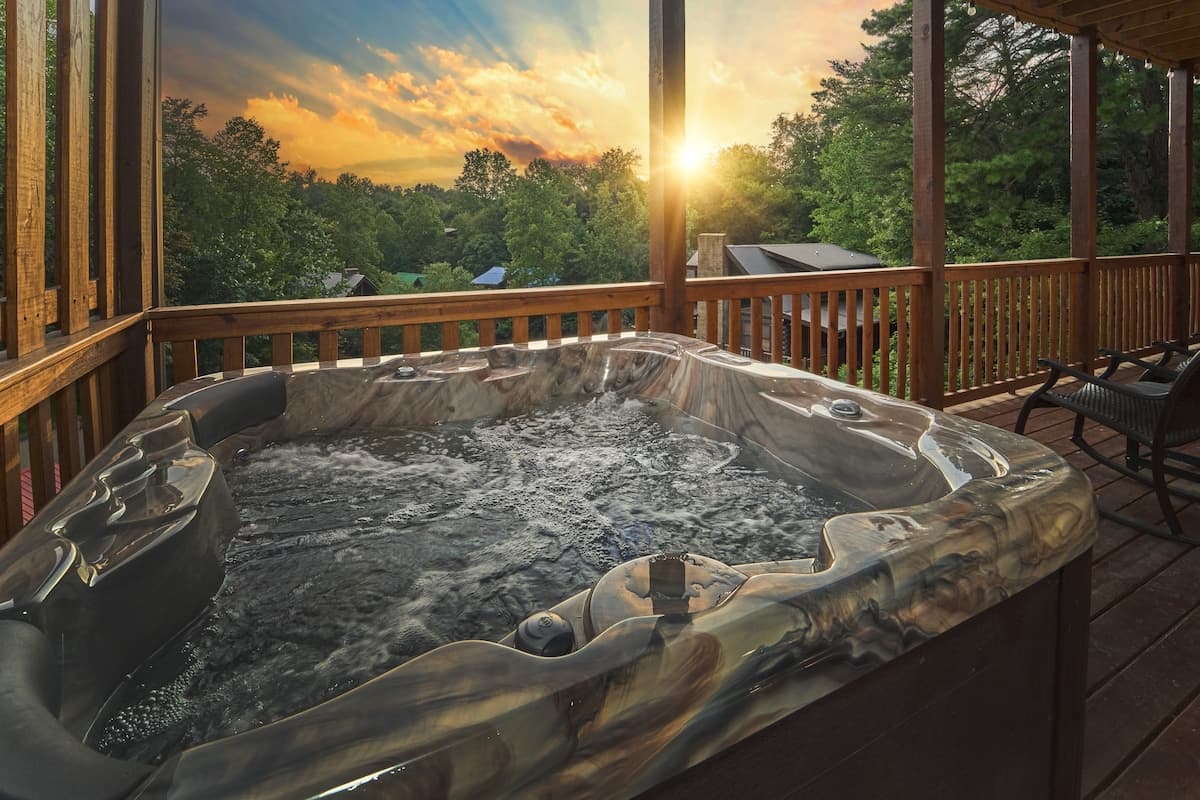 Soak in the private hot tub while enjoying breathtaking sunset and mountain views. This covered deck retreat is perfect for unwinding after a day of adventure. Whether it's a romantic evening or a relaxing break, this spa-like experience awaits!