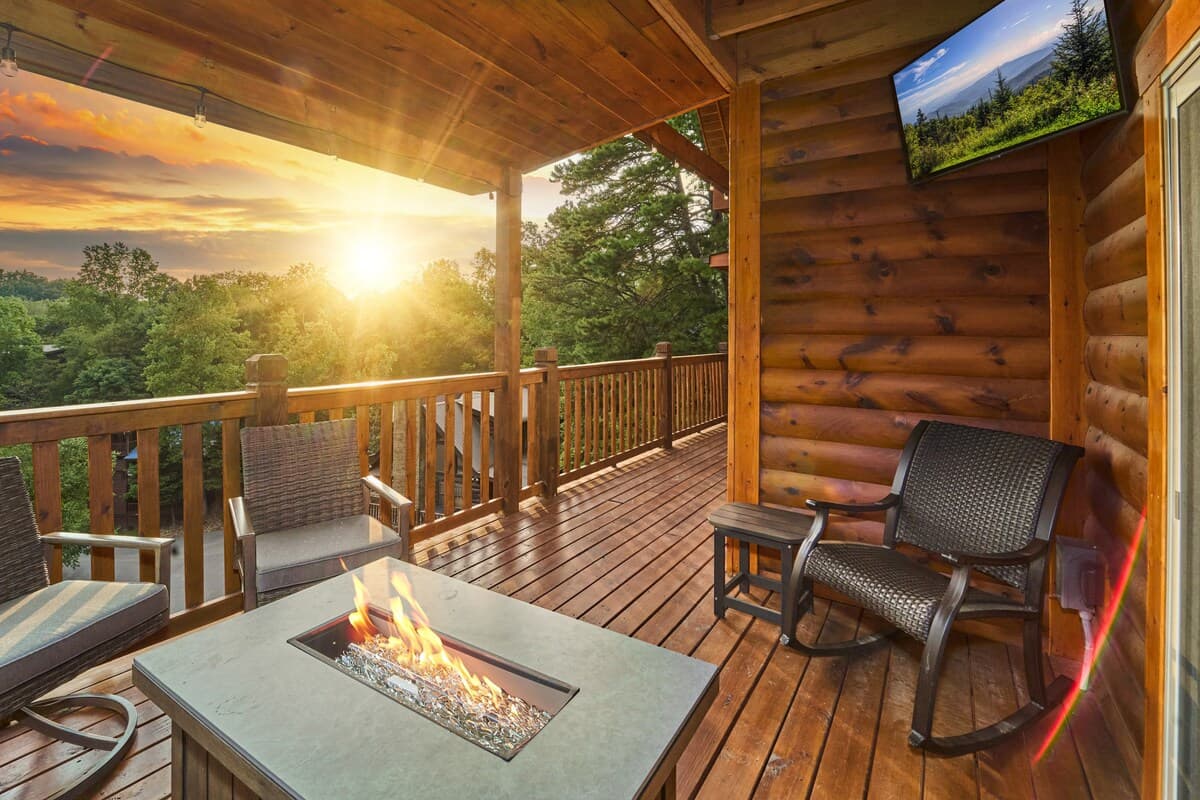 "Cozy up by the outdoor fire table on the deck while enjoying a stunning view. Relax on the comfortable seating and watch your favorite shows on the exterior TV. The perfect spot to unwind, sip a drink, and take in the beauty of the mountains!