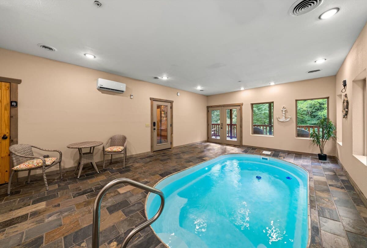 Enjoy a private, year-round heated indoor pool with 24/7 access! Perfect for families, couples, and groups, this space features a secure key door for child safety and scenic views. Relax in a climate-controlled oasis, ideal for any season.