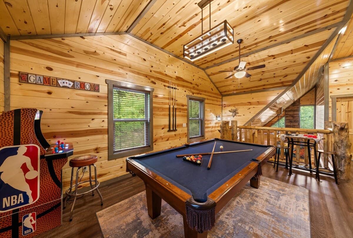 Unwind in the game room, where adults can enjoy a pool table while kids have fun on two arcade machines! This cozy cabin-style space is perfect for friendly competition, late-night games, and family entertainment.