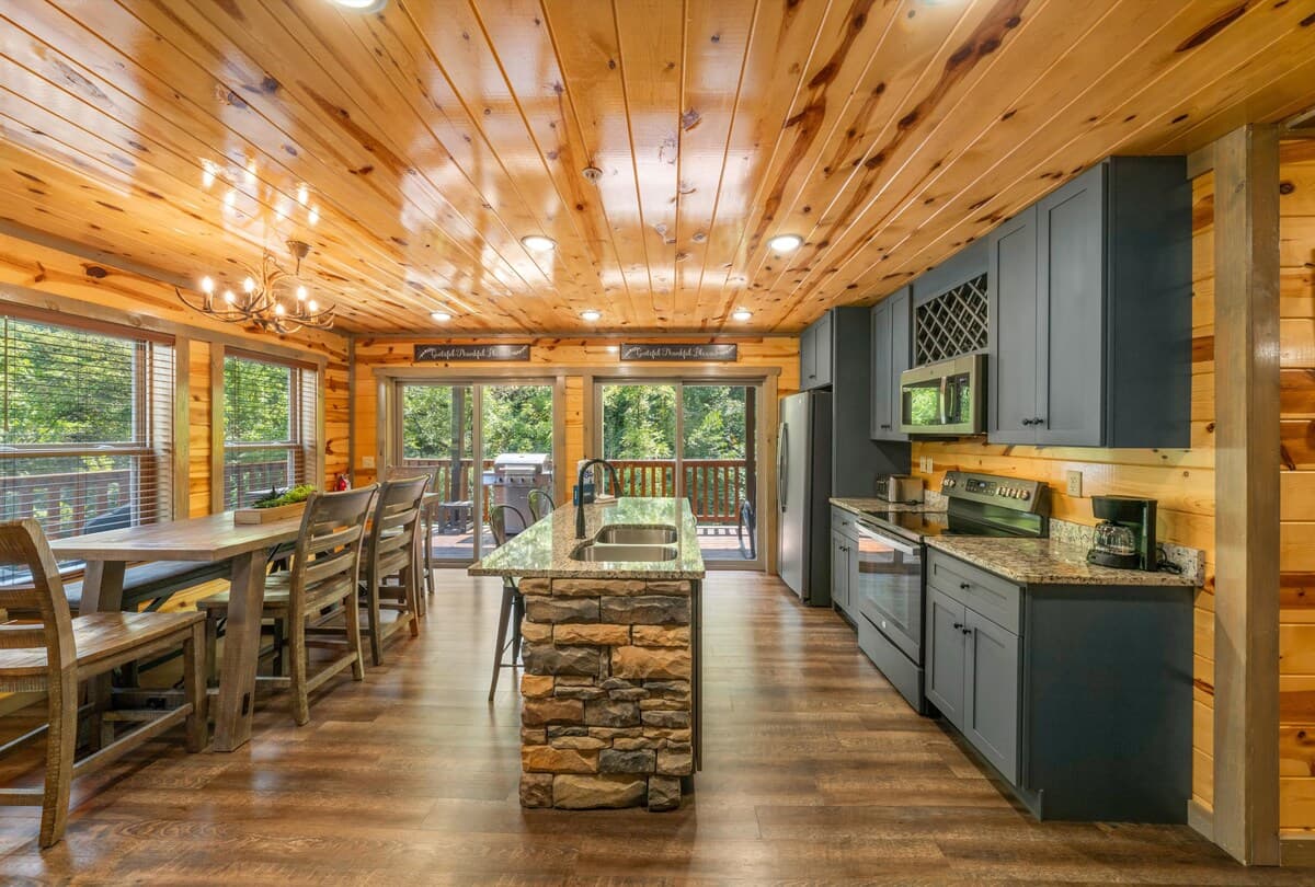 Enjoy a fully equipped kitchen stocked with all essentials for cooking and dining. The spacious layout includes a large dining table perfect for family meals. Modern appliances, ample counter space, and cabin charm make this the heart of your getaway