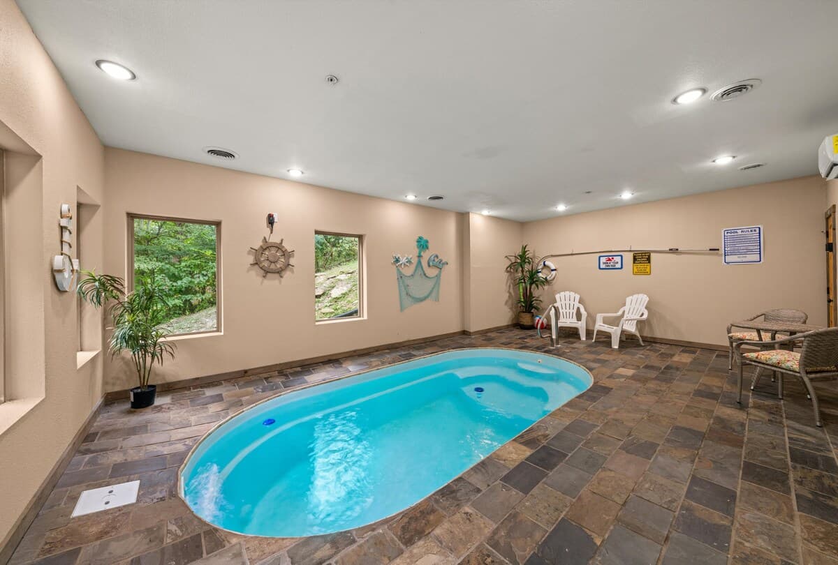 Enjoy a private, year-round heated indoor pool with 24/7 access! Perfect for families, couples, and groups, this space features a secure key door for child safety and scenic views. Relax in a climate-controlled oasis, ideal for any season.
