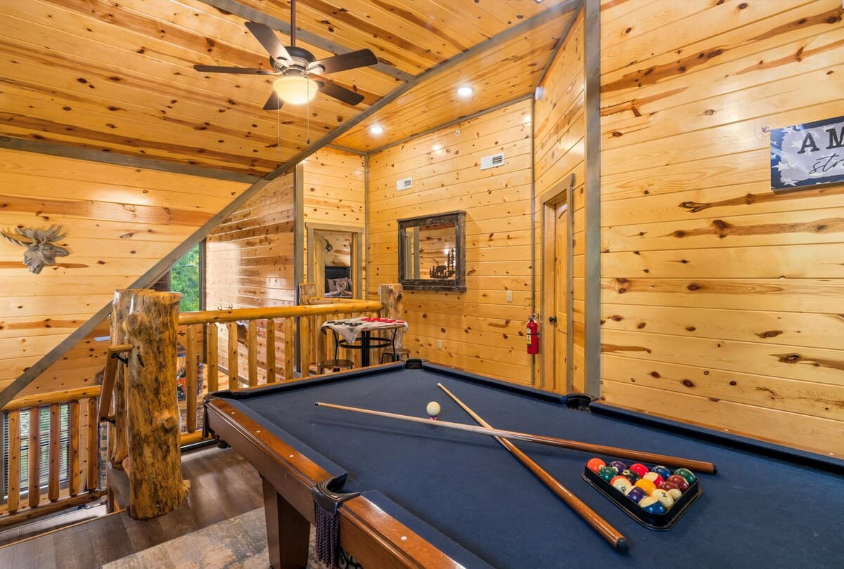 Unwind in the game room, where adults can enjoy a pool table while kids have fun on two arcade machines! This cozy cabin-style space is perfect for friendly competition, late-night games, and family entertainment.