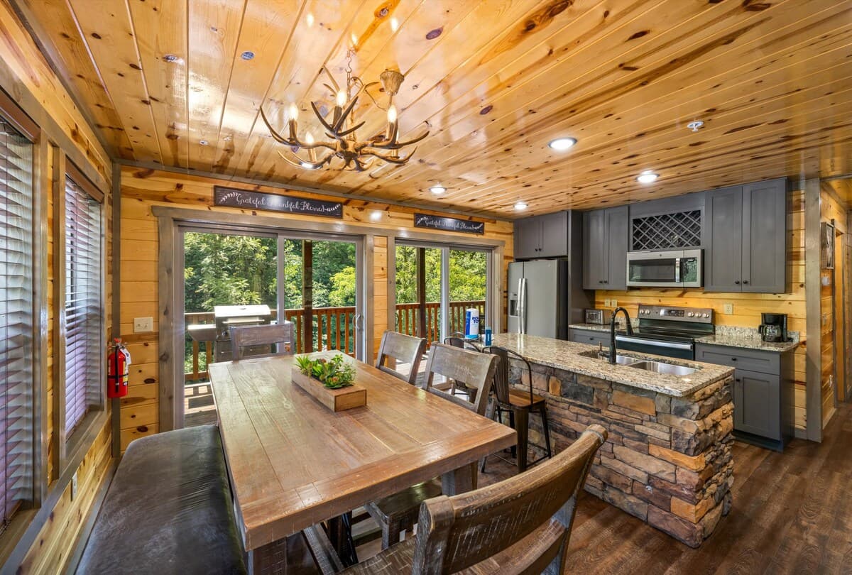 Gather around the dining table for six, with an extra seat at the kitchen island. Perfect for family meals and game nights, this cozy space blends rustic charm with modern comfort. Enjoy home-cooked meals in a beautifully designed cabin dining area!